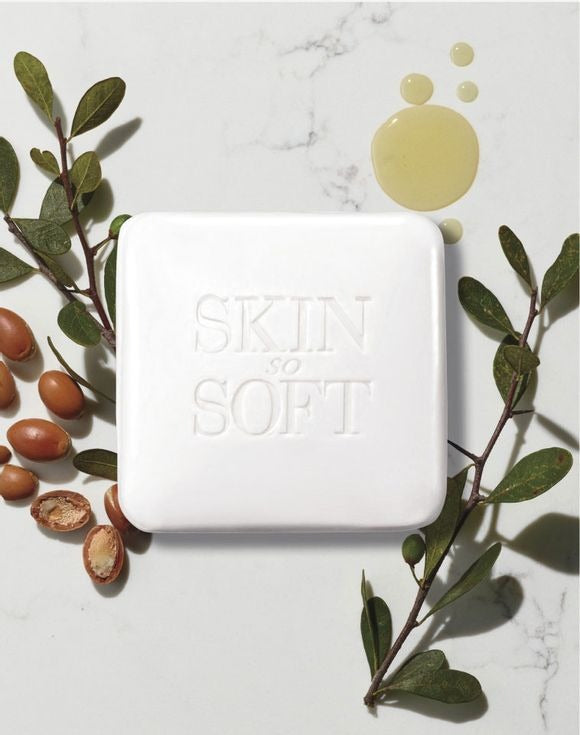 Skin So Soft Soft & Sensual Bar Soap with argan oil and natural ingredients on white marble surface.